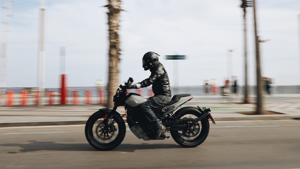 A motorcycle riding along the beach front